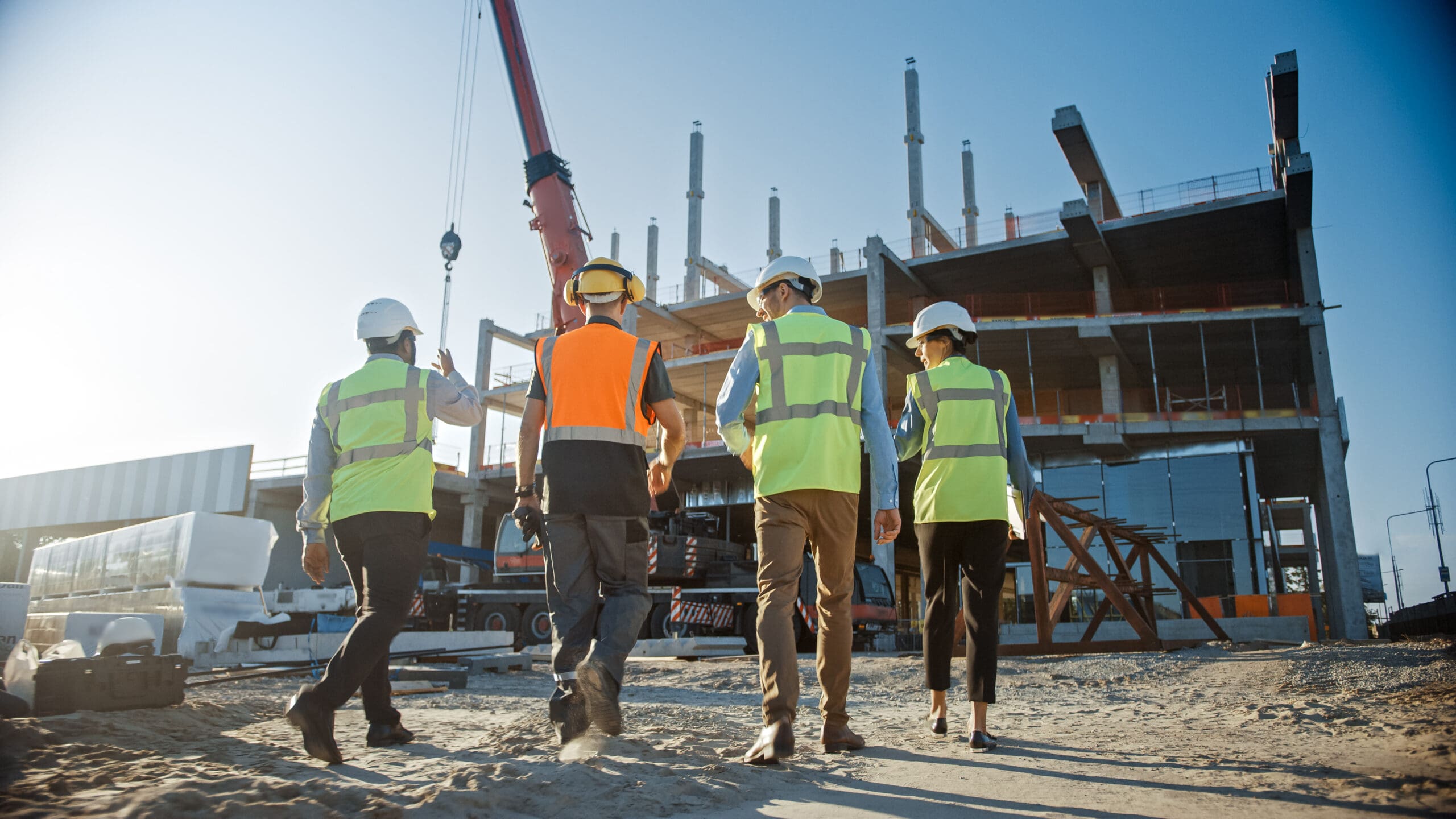 Diverse-Team-Of-Specialists-Inspect-Commercial-Industrial-Building-Construction-Site