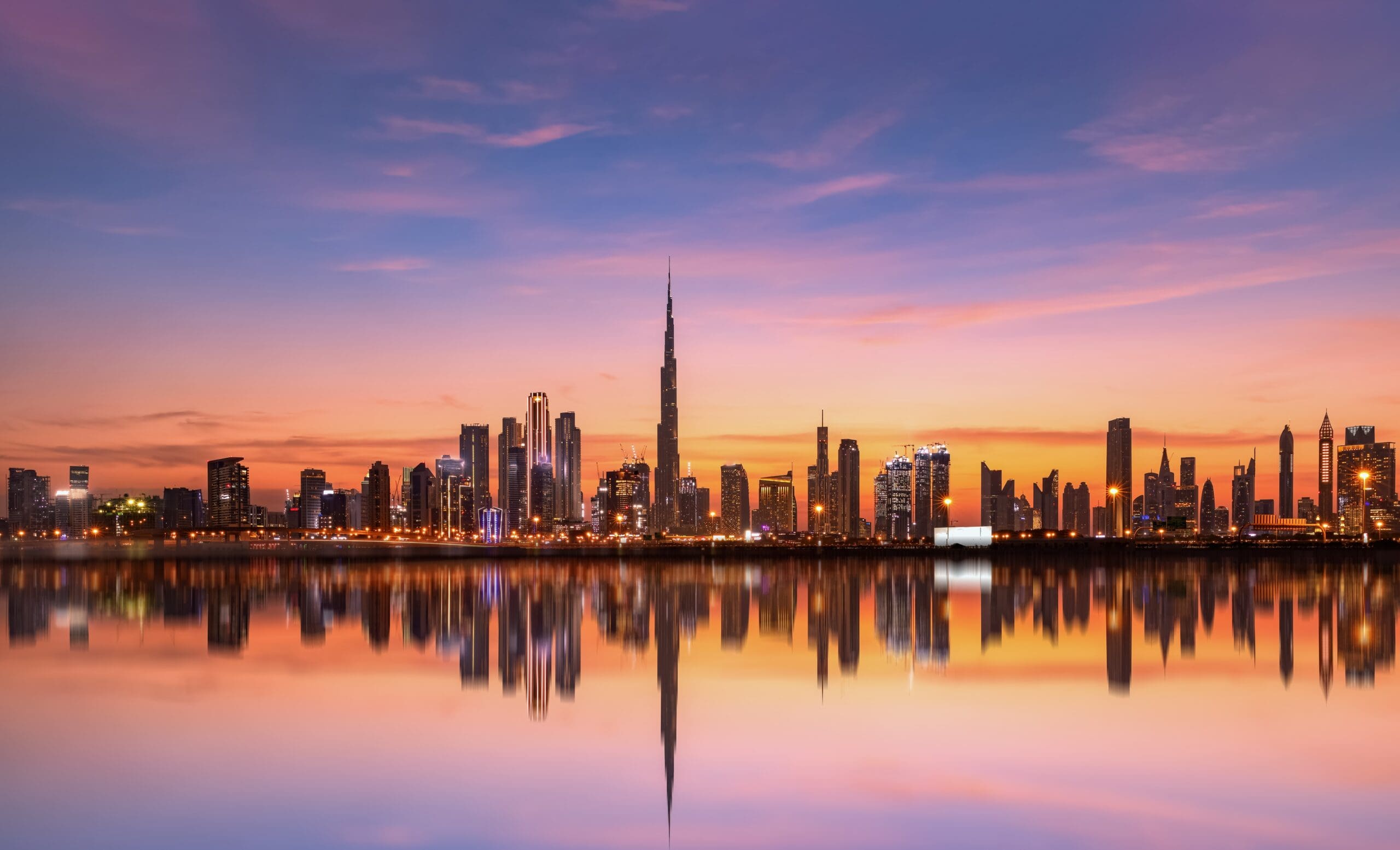 Panoramic-Dubai-Skyline-With-Reflection-In-Pastel-Sunset-Colours