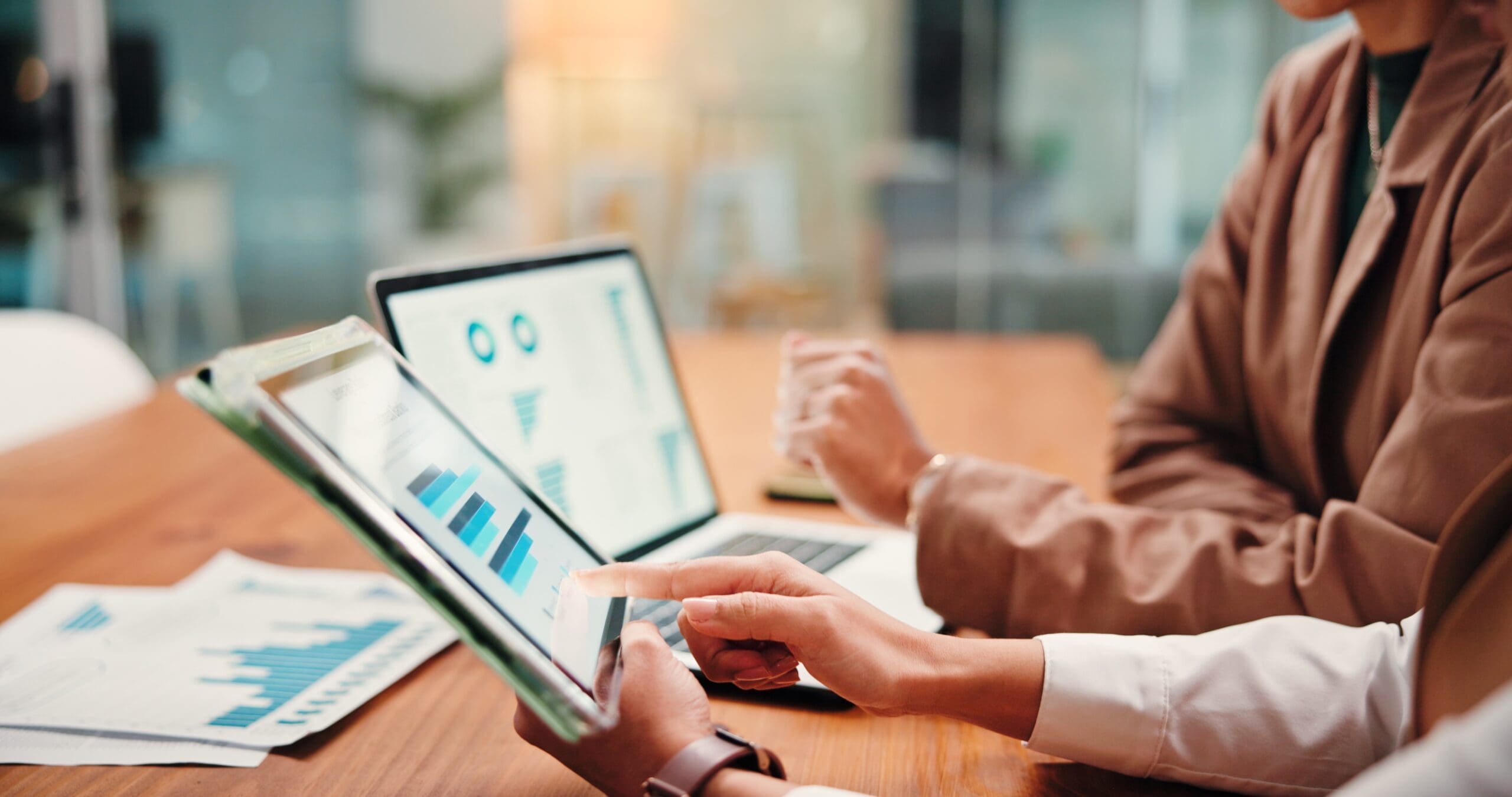 Hands-People-And-Graphs-On-Tablet-Screen-For-Finance-Results