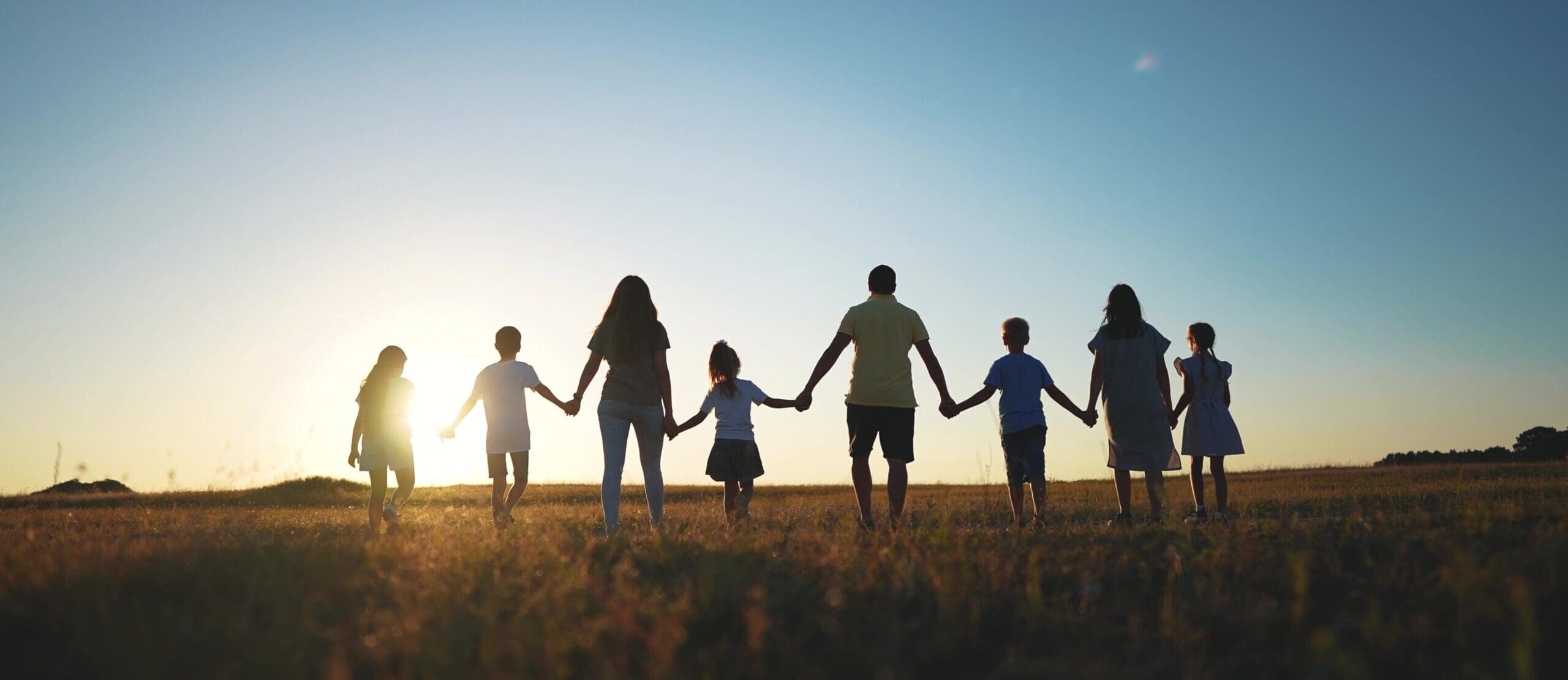 Big-Family-Huge-Community-Family-Holding-Hands-Walking